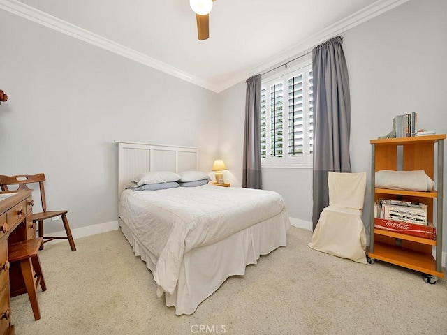 carpeted bedroom with ceiling fan and ornamental molding