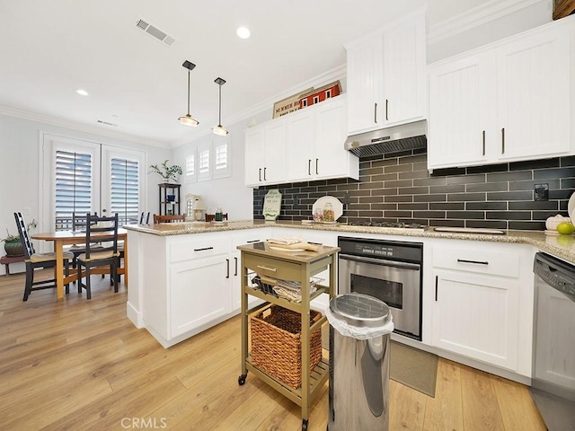 kitchen featuring light hardwood / wood-style floors, white cabinetry, stainless steel appliances, and hanging light fixtures