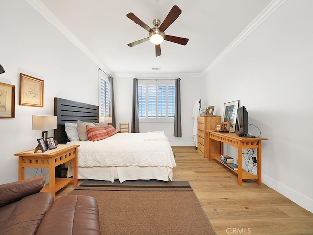 bedroom featuring ceiling fan, light wood-type flooring, and ornamental molding