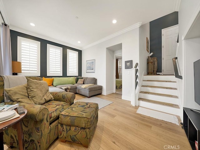 living room featuring light wood-type flooring and ornamental molding