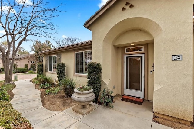 entrance to property featuring a patio