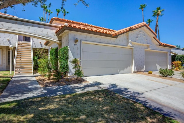 mediterranean / spanish house featuring a garage