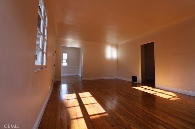 spare room featuring dark wood-type flooring