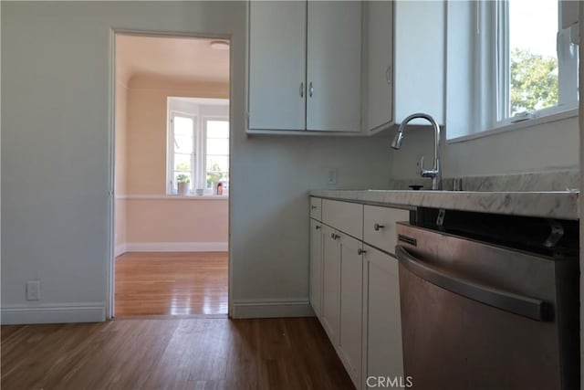 kitchen featuring white cabinets, wood-type flooring, dishwasher, and sink