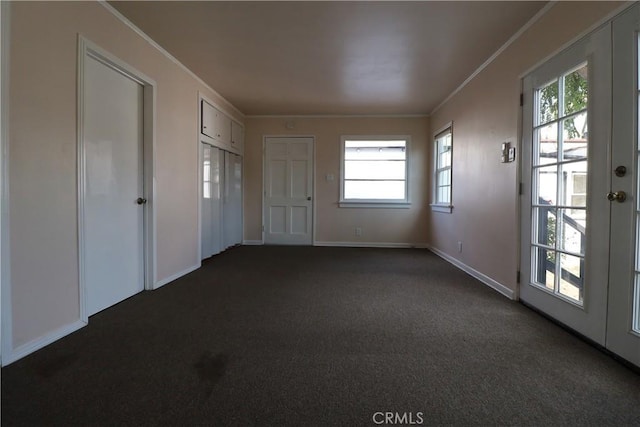 interior space with dark carpet and ornamental molding