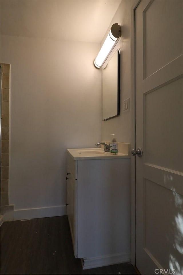 bathroom with hardwood / wood-style flooring and vanity