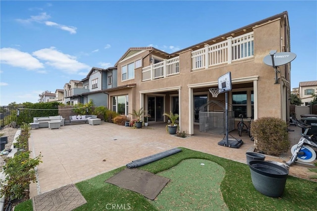 rear view of house with an outdoor living space and a patio area