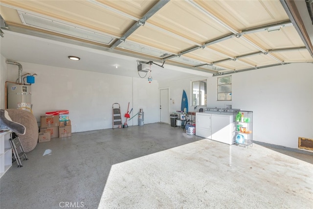 garage featuring secured water heater, a garage door opener, and washing machine and clothes dryer