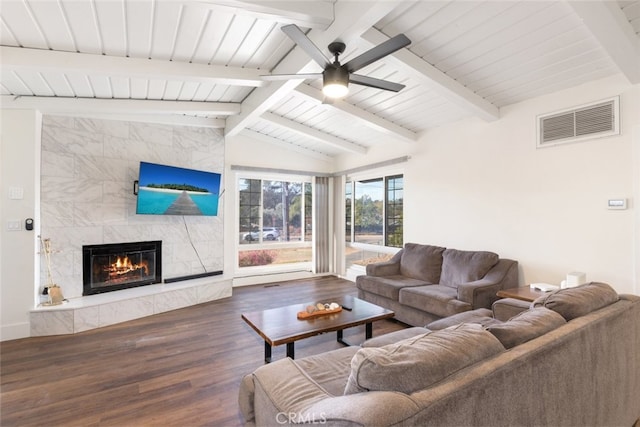 living room featuring a high end fireplace, vaulted ceiling with beams, dark hardwood / wood-style flooring, and ceiling fan