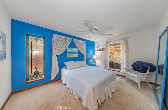 bedroom featuring ceiling fan and light colored carpet