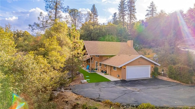 view of front of home with a front lawn and a garage