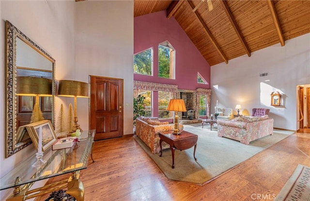 living room with plenty of natural light, high vaulted ceiling, and light hardwood / wood-style floors