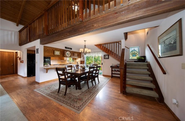 dining area with beam ceiling, high vaulted ceiling, hardwood / wood-style flooring, and an inviting chandelier