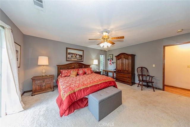 bedroom featuring ceiling fan and light carpet