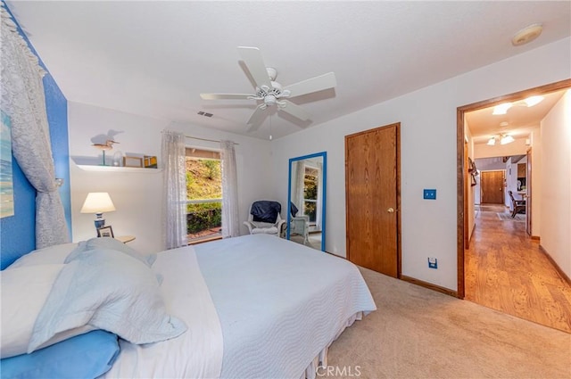 bedroom with ceiling fan and light hardwood / wood-style floors