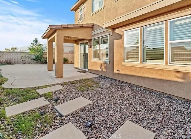 view of side of property with a patio