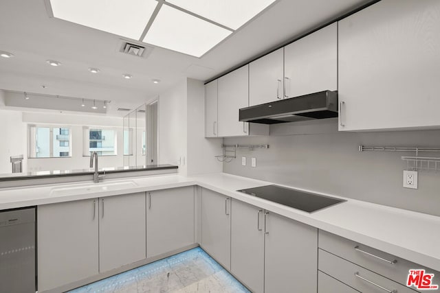 kitchen featuring white cabinets, black electric cooktop, stainless steel dishwasher, and sink