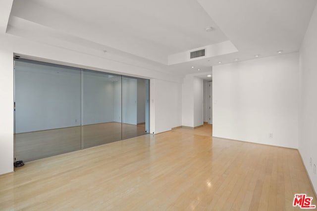 unfurnished room with light hardwood / wood-style floors