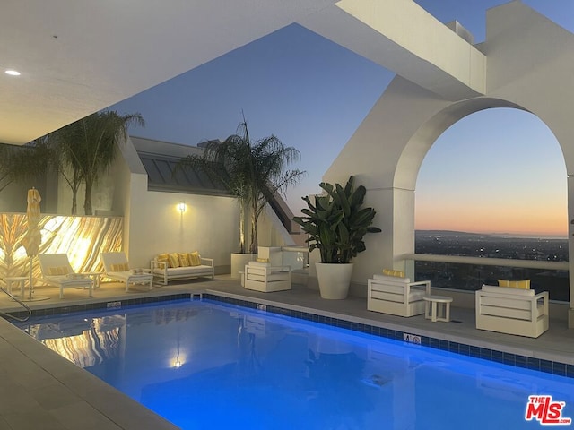 view of pool at dusk