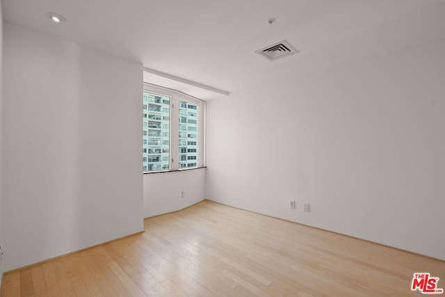 spare room with light hardwood / wood-style flooring