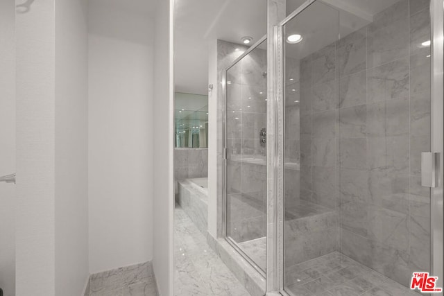 bathroom with separate shower and tub