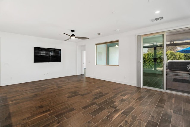 empty room featuring dark wood-type flooring and ceiling fan