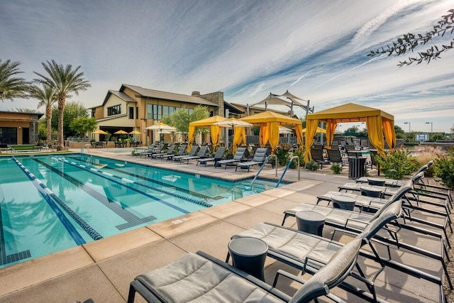 view of swimming pool with a gazebo and a patio