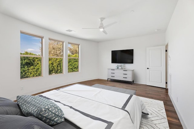 bedroom with dark hardwood / wood-style floors and ceiling fan