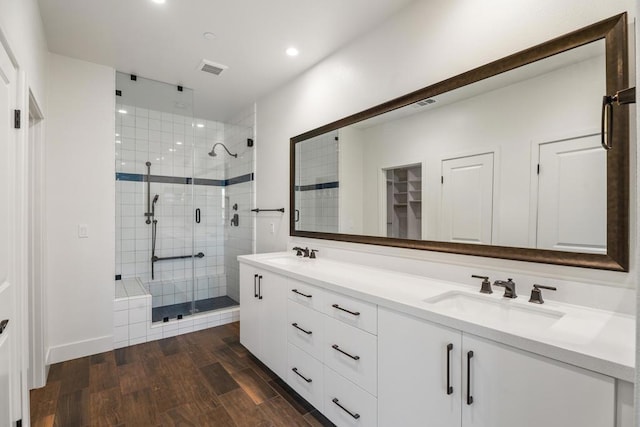 bathroom featuring vanity, hardwood / wood-style floors, and walk in shower