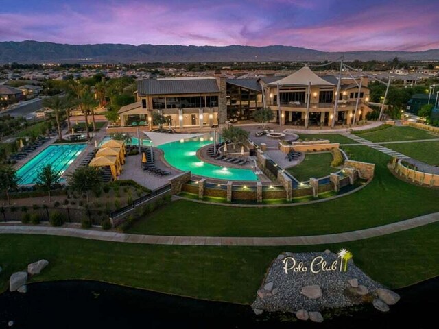 pool at dusk featuring a mountain view