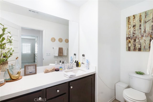 bathroom featuring vanity and toilet