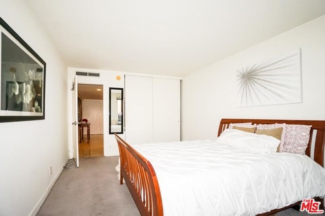 carpeted bedroom with a closet