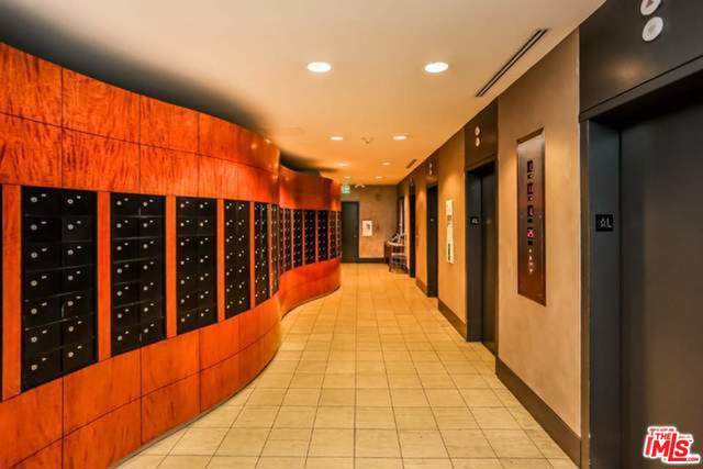 interior space with mail boxes, elevator, and light tile patterned flooring