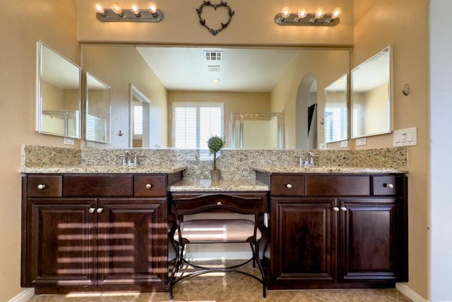 bathroom with tile patterned flooring, vanity, and a shower with shower door