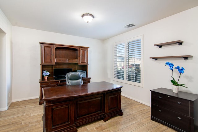 home office with light wood-type flooring