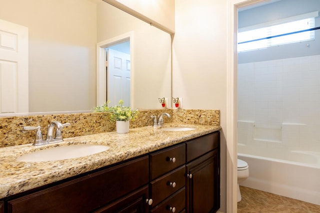 full bathroom with tile patterned floors, vanity, tub / shower combination, and toilet