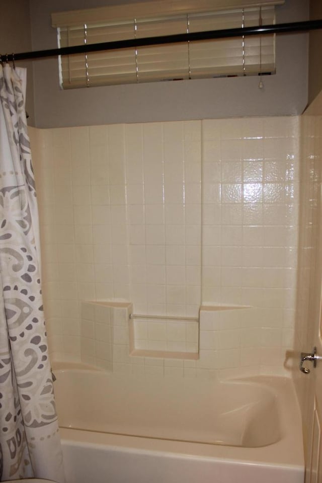 bathroom featuring shower / bathtub combination with curtain