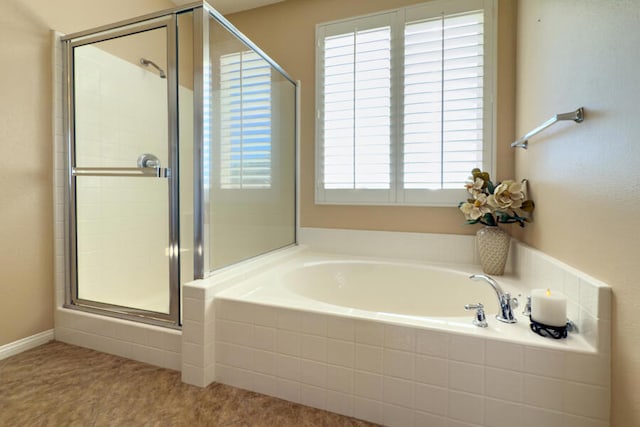 bathroom featuring independent shower and bath