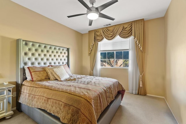 bedroom with ceiling fan and light carpet