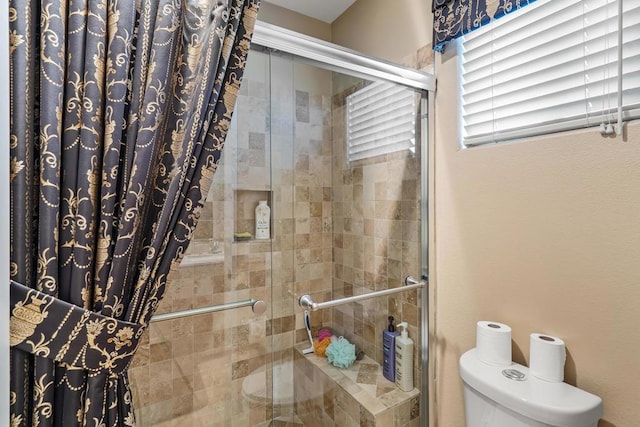 bathroom with toilet and walk in shower