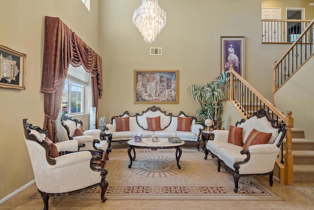 living room with a towering ceiling, an inviting chandelier, and light tile patterned flooring