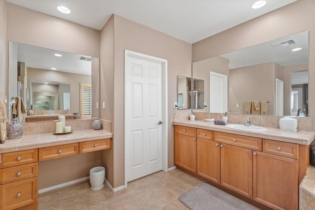 bathroom with decorative backsplash, tile patterned flooring, and vanity