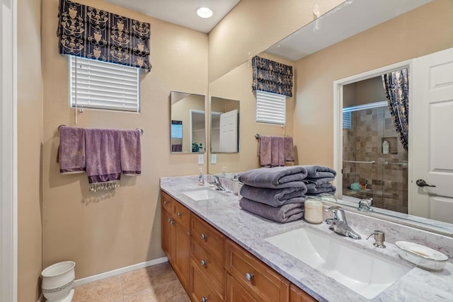 bathroom with tile patterned flooring, vanity, an enclosed shower, and a healthy amount of sunlight