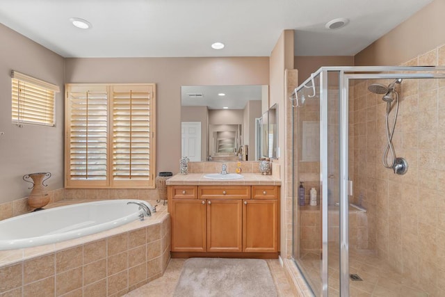 bathroom featuring tile patterned floors, plus walk in shower, and vanity