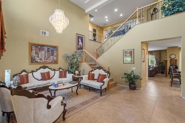 living room with a high ceiling, an inviting chandelier, and light tile patterned flooring