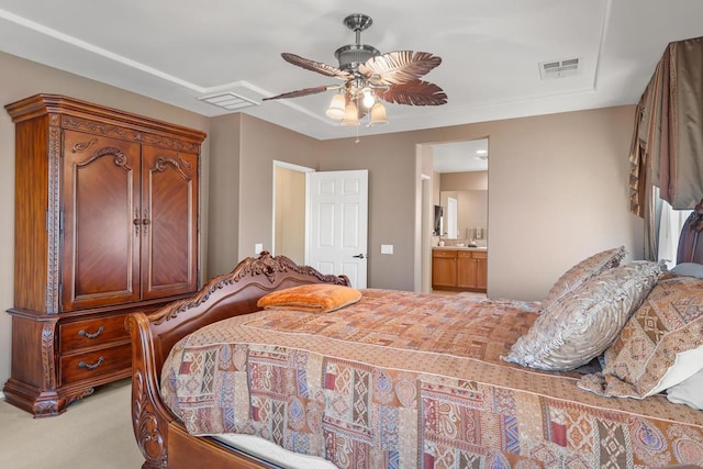 bedroom with ceiling fan, ensuite bathroom, and light carpet