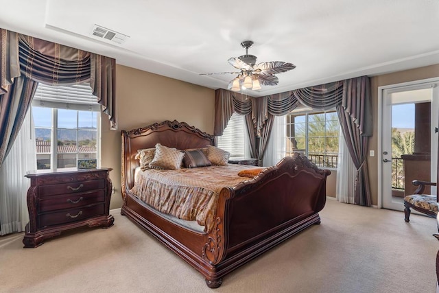 bedroom with access to exterior, carpet, ceiling fan, and a mountain view