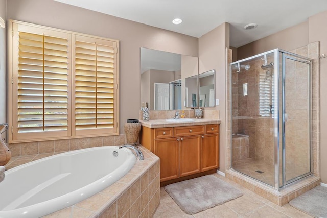 bathroom featuring separate shower and tub, tile patterned flooring, and vanity