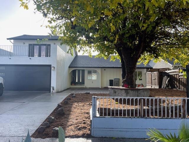 view of front facade with a balcony and a garage