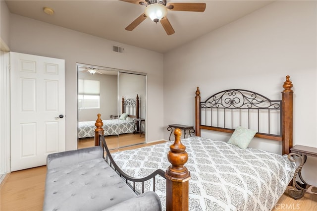 bedroom featuring ceiling fan, a closet, and light hardwood / wood-style flooring